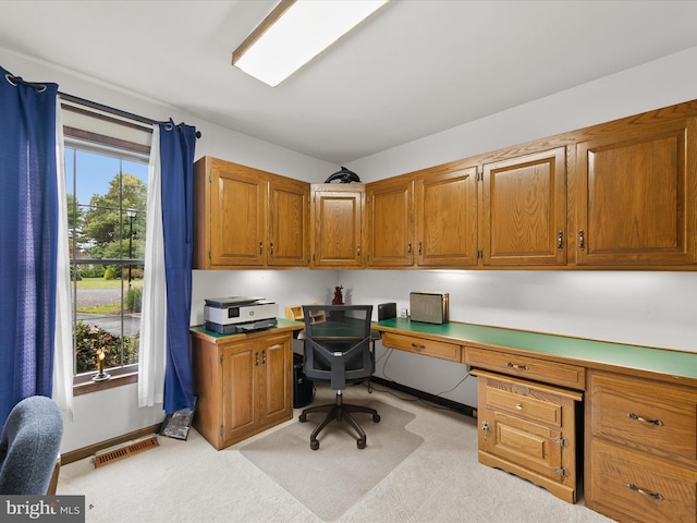 carpeted home office with built in desk