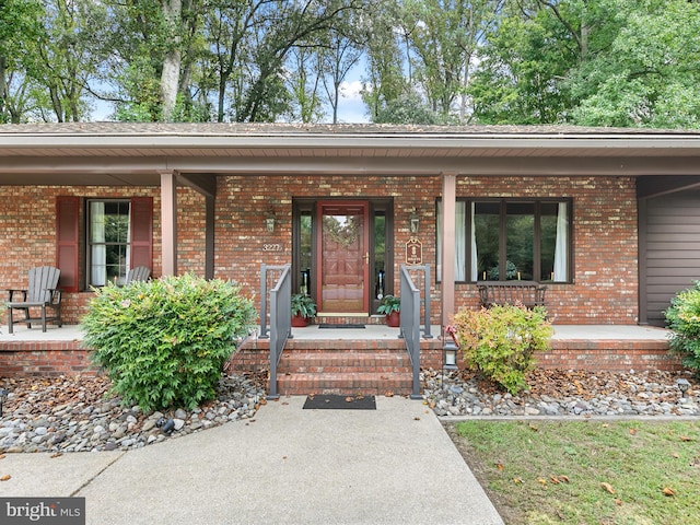 view of exterior entry with a porch