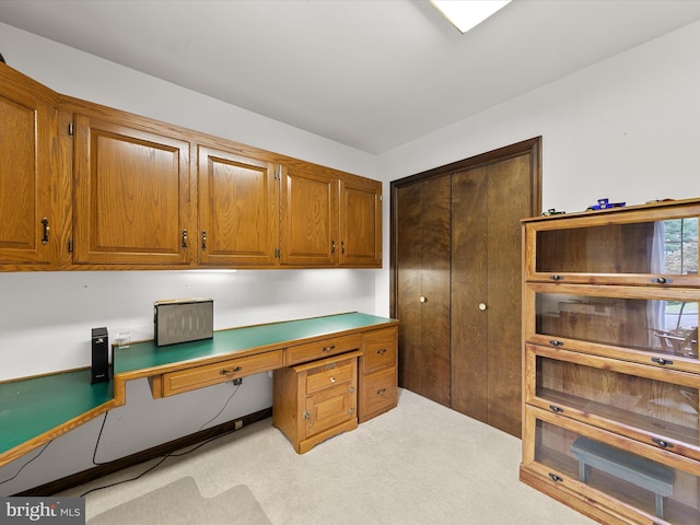 carpeted office with built in desk