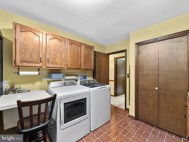 laundry area featuring independent washer and dryer and cabinets