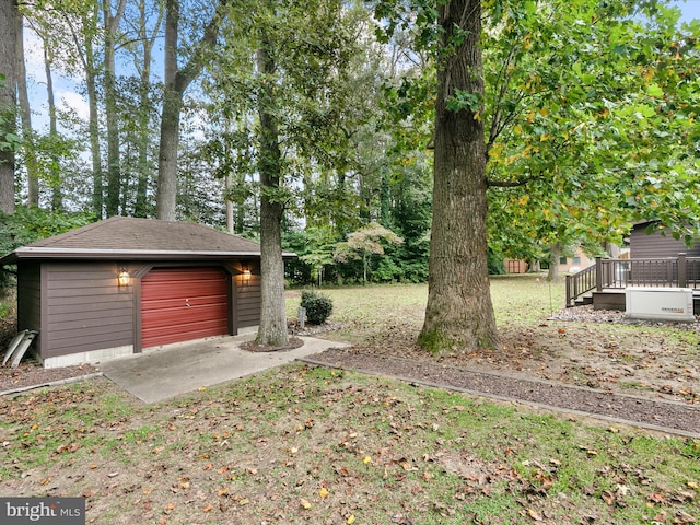 view of yard featuring an outdoor structure, a deck, and a garage