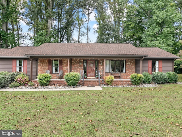 ranch-style house featuring a porch and a front lawn