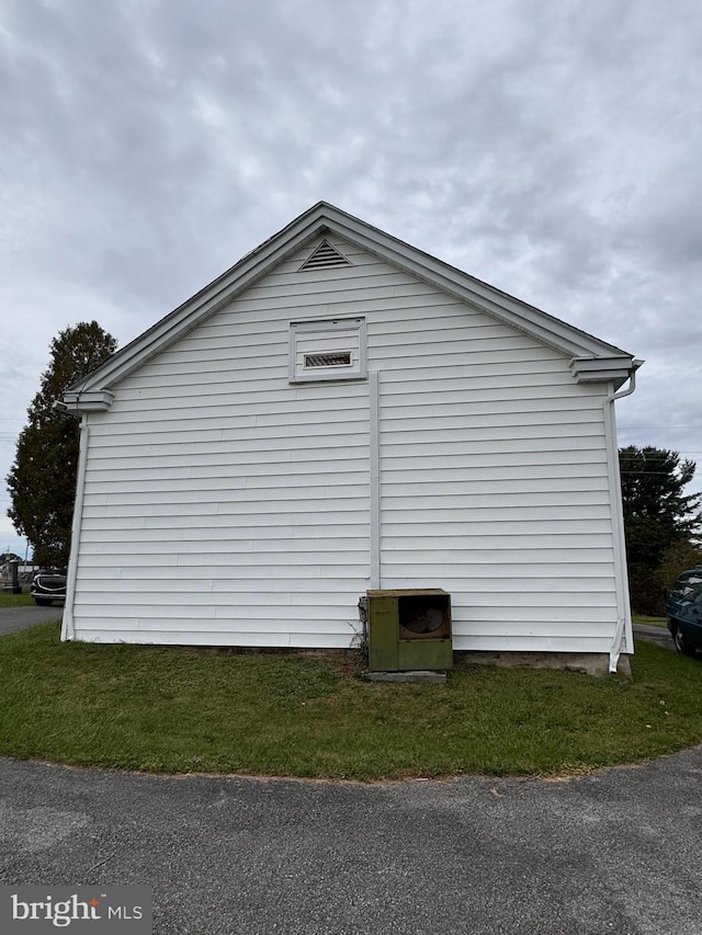 view of side of home featuring a yard