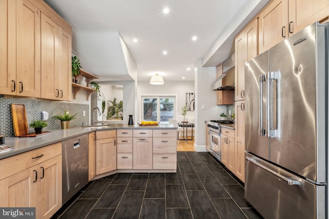 kitchen featuring light brown cabinetry, premium appliances, and sink