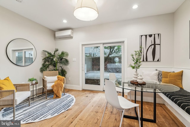 interior space featuring light wood-type flooring and a wall mounted AC