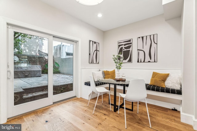 dining space featuring wood-type flooring and breakfast area