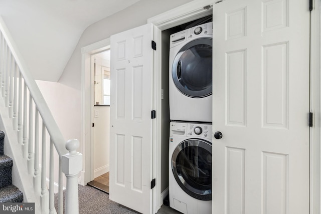 laundry room with stacked washing maching and dryer