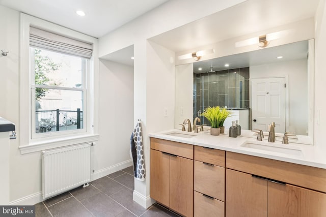 bathroom featuring tile patterned flooring, vanity, walk in shower, and radiator heating unit