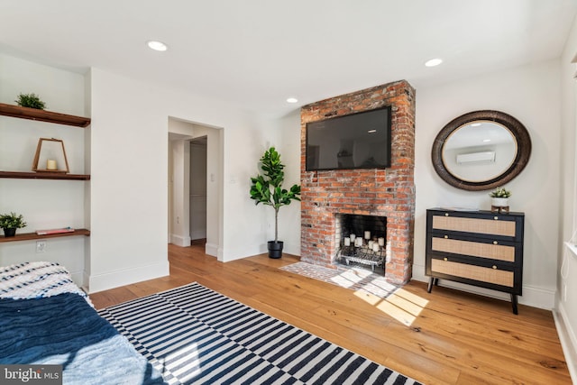 living room with a fireplace and light hardwood / wood-style flooring