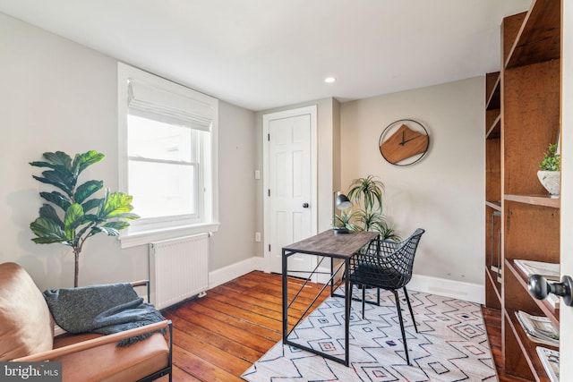 office featuring radiator and light hardwood / wood-style floors