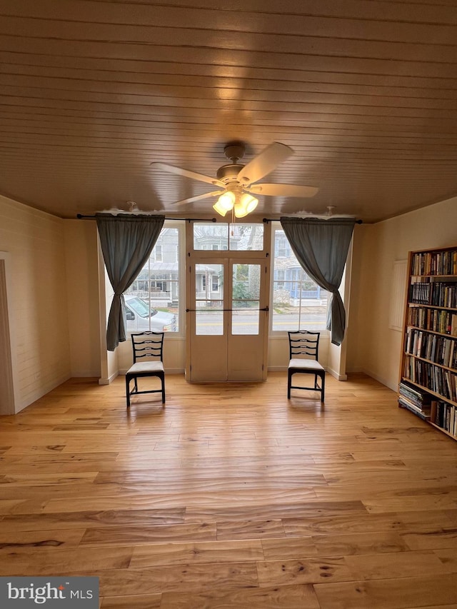 sitting room featuring wooden ceiling, light hardwood / wood-style floors, and ceiling fan