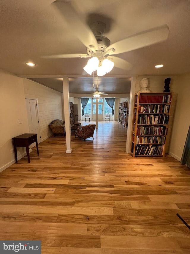 unfurnished dining area featuring light wood-type flooring and ceiling fan