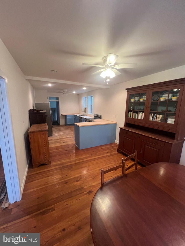 dining space with ceiling fan and hardwood / wood-style flooring