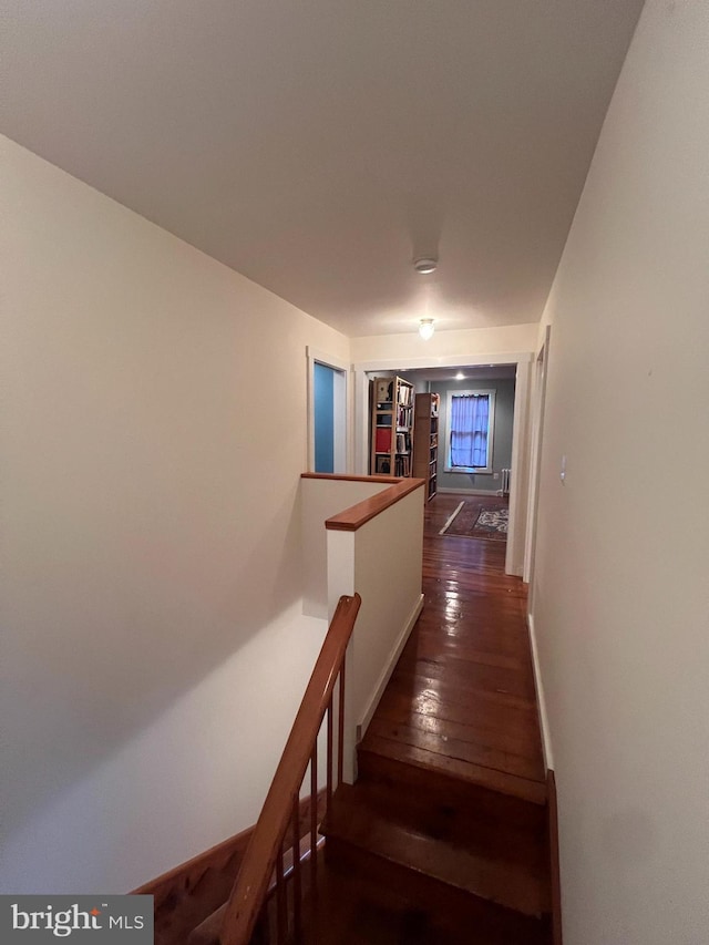 staircase with hardwood / wood-style flooring