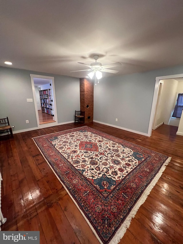 interior space featuring dark wood-type flooring and ceiling fan