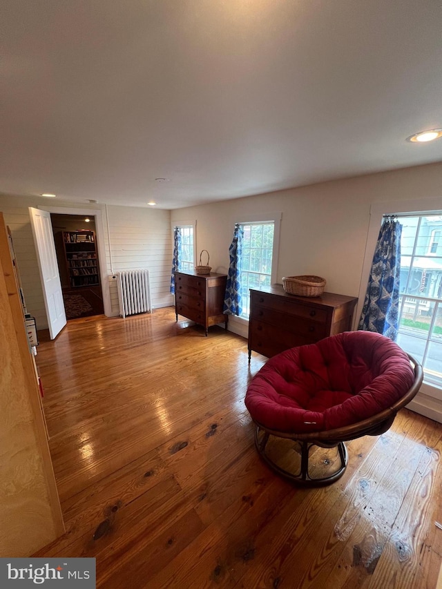 interior space featuring wood-type flooring and radiator heating unit