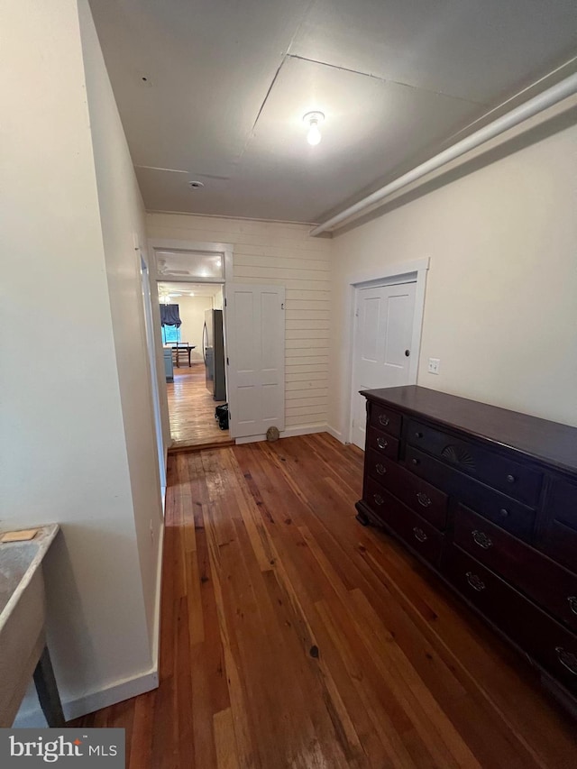 hallway with dark wood-type flooring