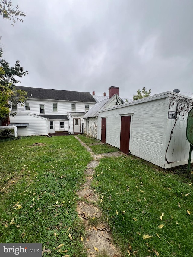 rear view of house with a lawn