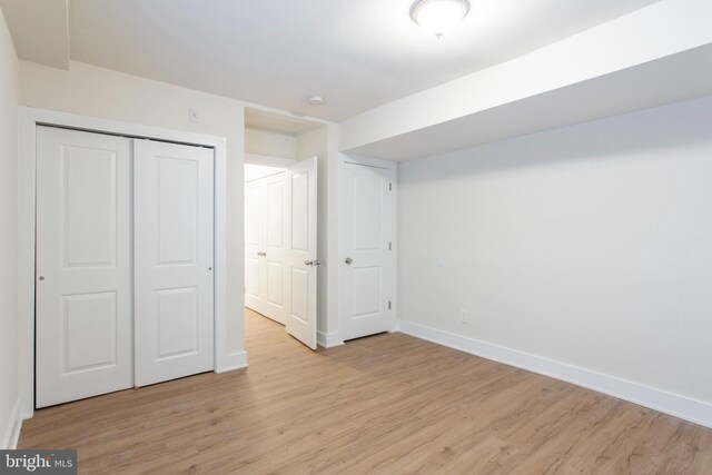 unfurnished bedroom featuring a closet and light hardwood / wood-style floors