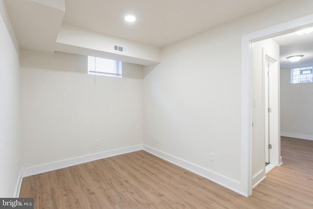 basement with light hardwood / wood-style flooring