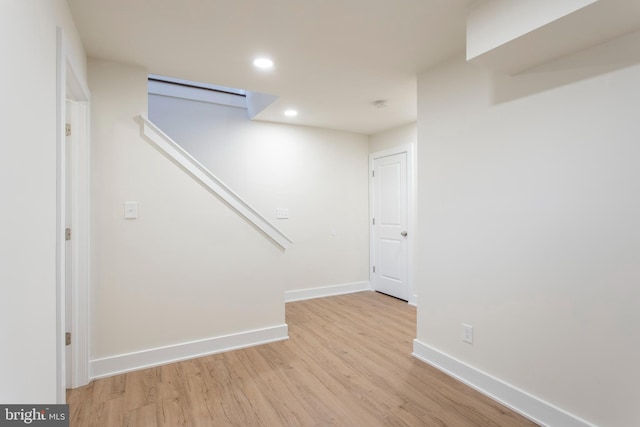 basement with light hardwood / wood-style floors