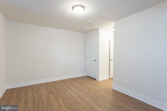 unfurnished room with light wood-type flooring