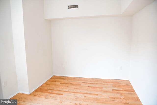 empty room with hardwood / wood-style flooring