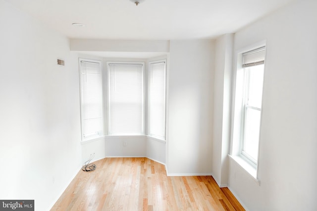 spare room with light wood-type flooring