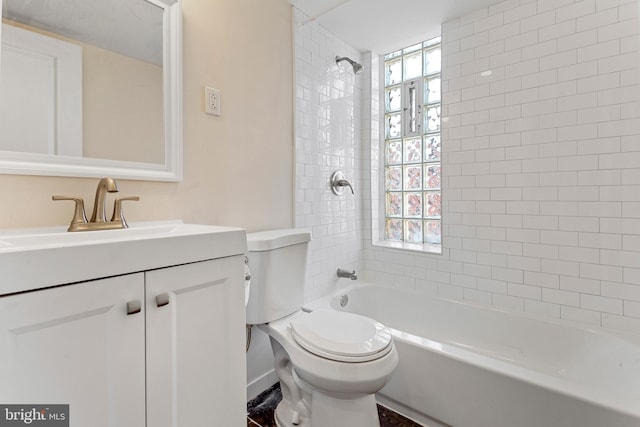 full bathroom featuring tiled shower / bath combo, vanity, and toilet