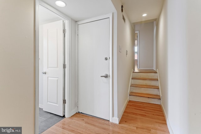 corridor with hardwood / wood-style floors