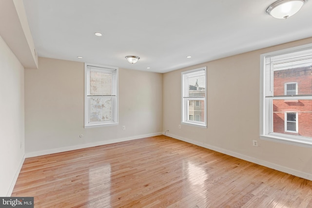 empty room featuring light hardwood / wood-style flooring and a healthy amount of sunlight