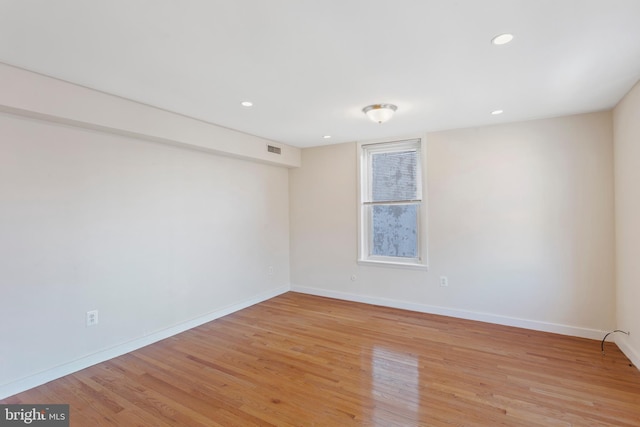 unfurnished room with light hardwood / wood-style floors