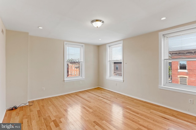 unfurnished room with light hardwood / wood-style flooring