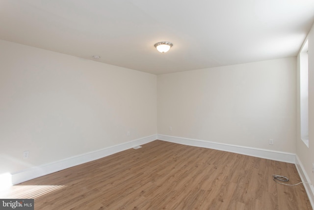 spare room featuring hardwood / wood-style floors