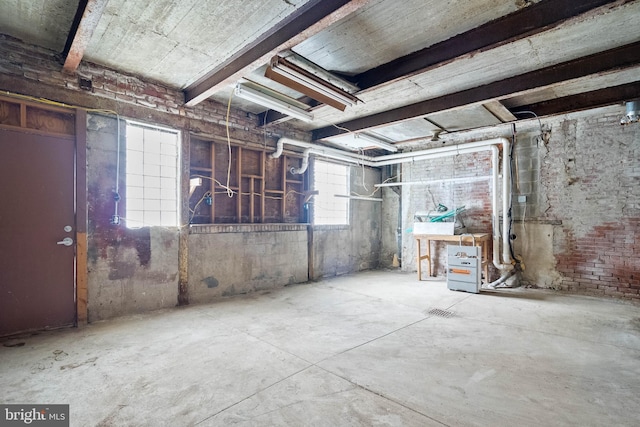 basement featuring brick wall