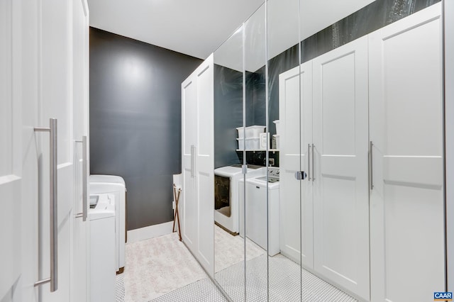 washroom with separate washer and dryer and light tile patterned floors