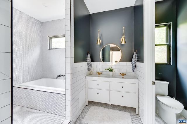 bathroom with plenty of natural light, toilet, and tile patterned floors