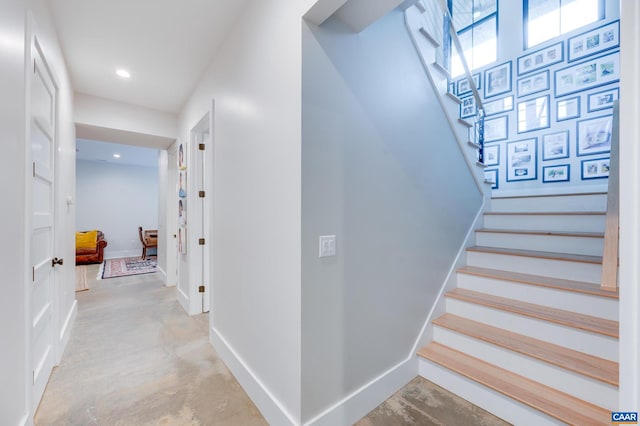 stairs featuring concrete floors