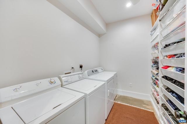 laundry area with light colored carpet and washing machine and dryer