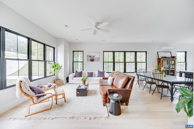 living room featuring light hardwood / wood-style flooring and ceiling fan