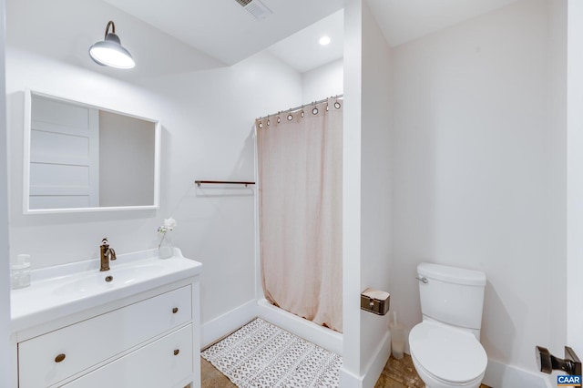 bathroom featuring vanity, tile patterned floors, toilet, and curtained shower