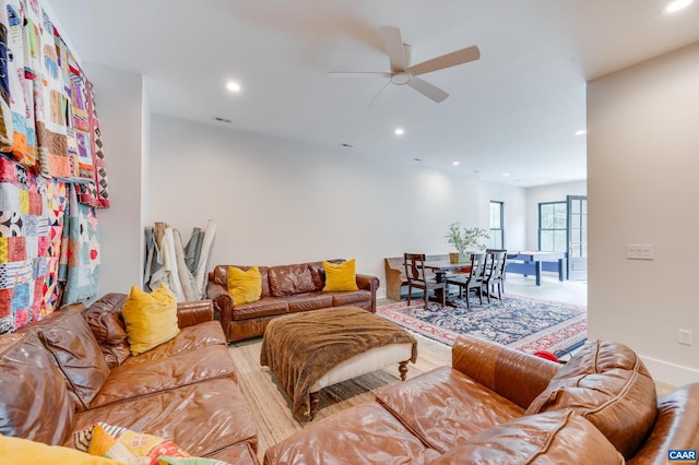 living room featuring light hardwood / wood-style flooring and ceiling fan