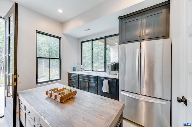 kitchen with sink and stainless steel refrigerator