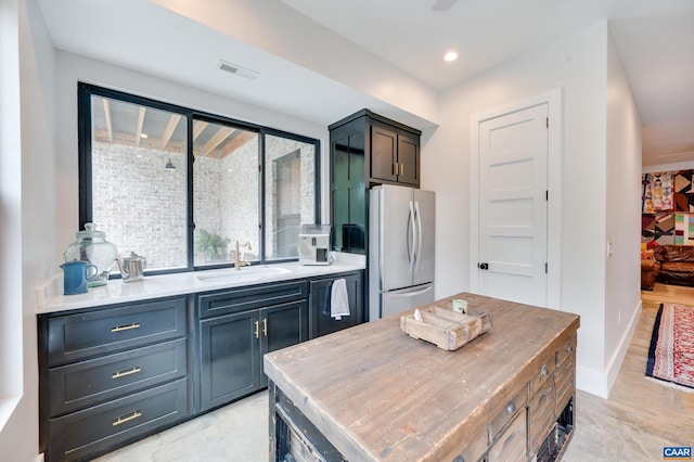 kitchen with sink and stainless steel refrigerator