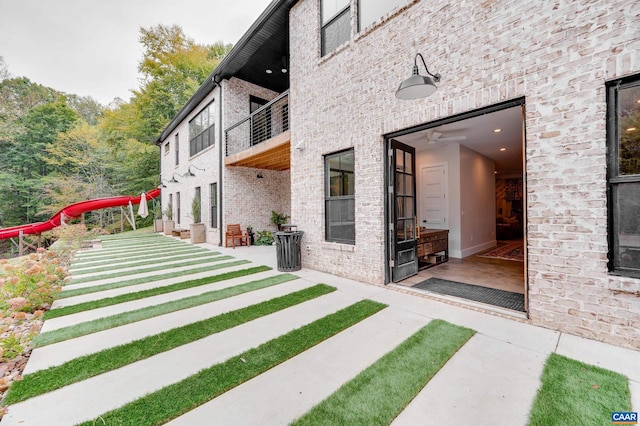 view of yard with ceiling fan and a patio area