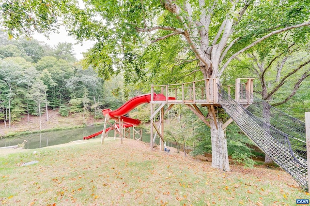 view of yard featuring a playground and a water view