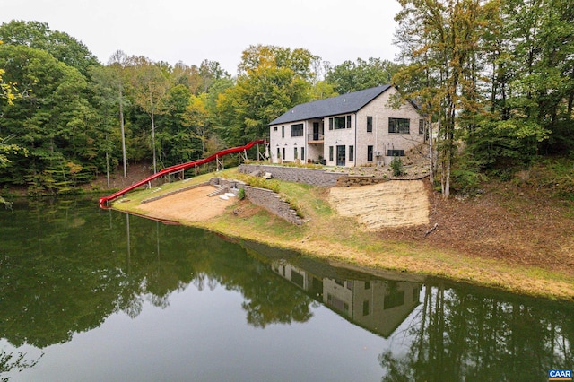 rear view of property with a water view