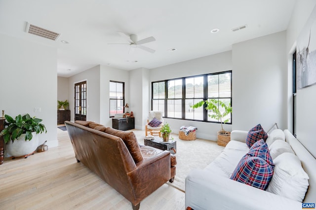 living room with ceiling fan and light hardwood / wood-style flooring