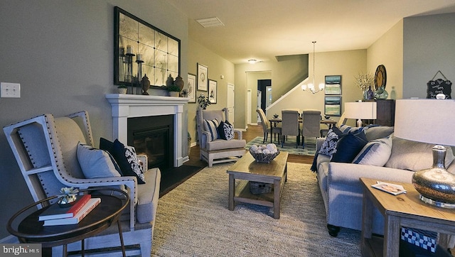 living room featuring an inviting chandelier and dark hardwood / wood-style flooring