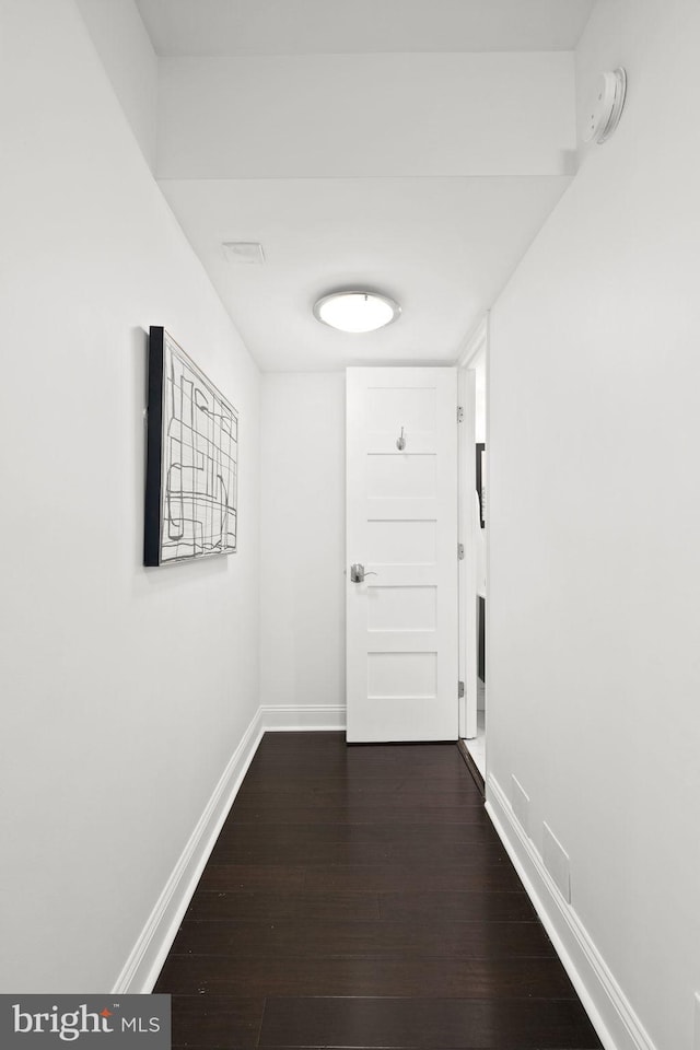 hallway with dark hardwood / wood-style flooring